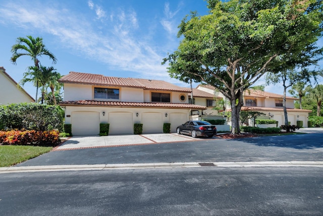 7940 La Mirada Dr, Boca Raton, FL 33433 - mediterranean / spanish-style home with a tiled roof, stucco siding, driveway, and a garage