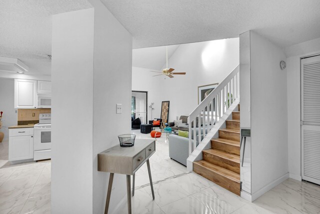 7940 La Mirada Dr, Boca Raton, FL 33433 - staircase featuring marble finish floors, a textured ceiling, and a ceiling fan