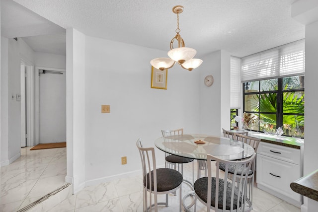 7940 La Mirada Dr, Boca Raton, FL 33433 - dining room featuring light marble finish floors, a textured ceiling, and baseboards