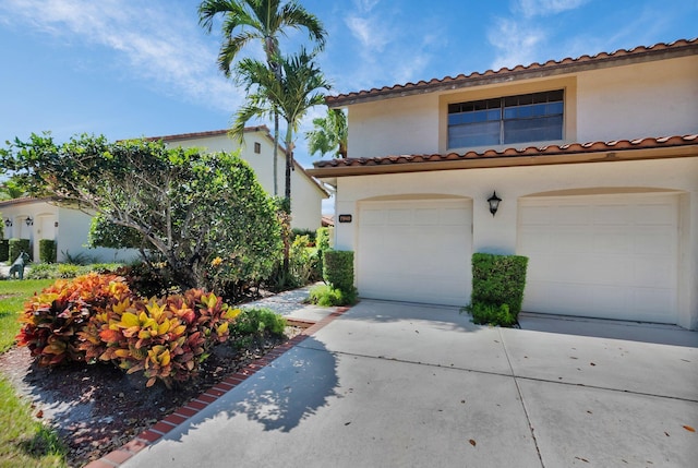 7940 La Mirada Dr, Boca Raton, FL 33433 - mediterranean / spanish house with an attached garage, concrete driveway, stucco siding, and a tile roof