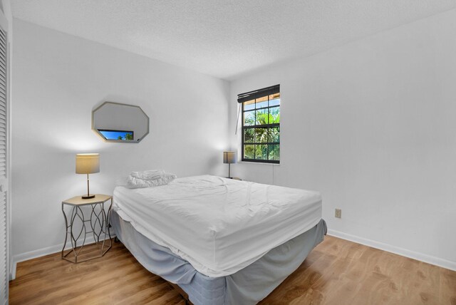 7940 La Mirada Dr, Boca Raton, FL 33433 - bedroom featuring wood finished floors, baseboards, and a textured ceiling