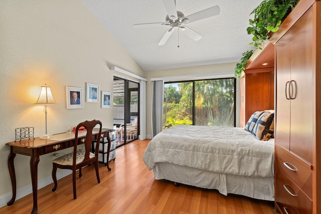 bedroom with access to outside, a textured ceiling, light wood-style flooring, baseboards, and lofted ceiling