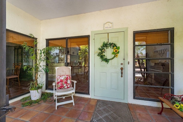 property entrance featuring stucco siding