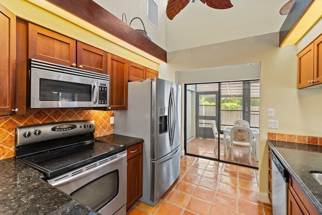 kitchen featuring brown cabinets, stainless steel appliances, a ceiling fan, backsplash, and visible vents