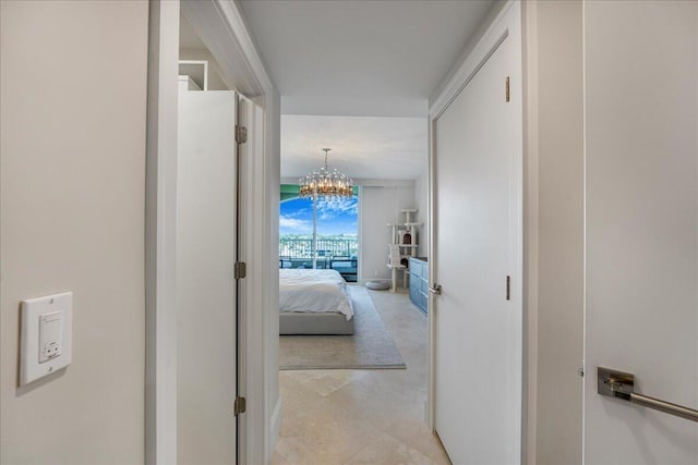 3720 S Ocean Blvd Unit 603, Highland Beach, FL 33487 - hall with a chandelier and light tile patterned flooring