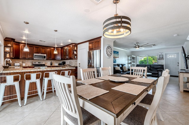 3338 NW 69th St, Fort Lauderdale, FL 33309 - dining room with visible vents, ceiling fan with notable chandelier, a textured ceiling, and light tile patterned floors
