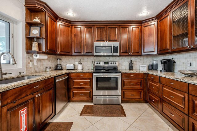 3338 NW 69th St, Fort Lauderdale, FL 33309 - kitchen featuring open shelves, stainless steel appliances, decorative backsplash, and a sink