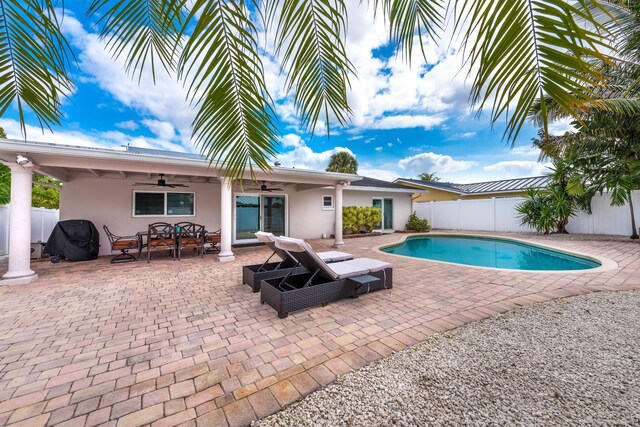 3338 NW 69th St, Fort Lauderdale, FL 33309 - view of pool with a patio area, a ceiling fan, a fenced in pool, and a fenced backyard