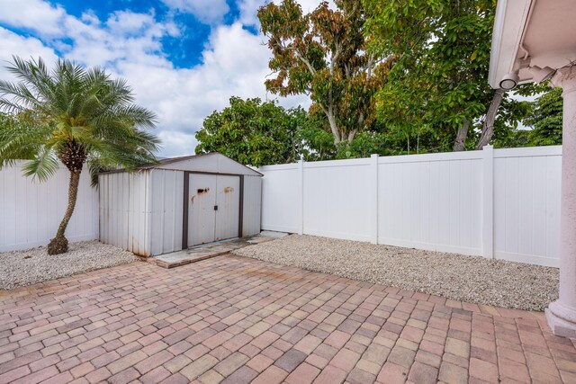 3338 NW 69th St, Fort Lauderdale, FL 33309 - view of patio / terrace featuring a fenced backyard, a storage unit, and an outbuilding