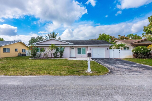 3338 NW 69th St, Fort Lauderdale, FL 33309 - single story home with a garage, driveway, a front lawn, and stucco siding
