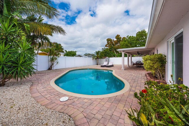 3338 NW 69th St, Fort Lauderdale, FL 33309 - view of swimming pool with a patio area, a fenced in pool, a fenced backyard, and ceiling fan
