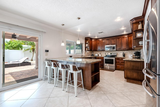 3338 NW 69th St, Fort Lauderdale, FL 33309 - kitchen with open shelves, light stone countertops, stainless steel appliances, and a peninsula