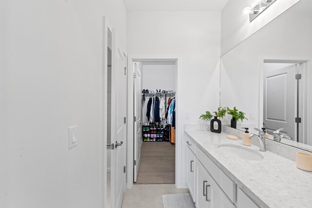 8781 Corvus Dr, Lake Worth, FL 33467 - bathroom featuring tile patterned flooring, vanity, and a spacious closet