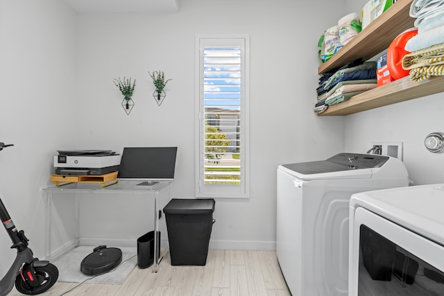 8781 Corvus Dr, Lake Worth, FL 33467 - laundry room featuring washing machine and dryer, baseboards, laundry area, and light wood-type flooring