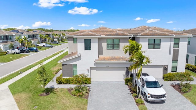 8781 Corvus Dr, Lake Worth, FL 33467 - view of front facade with a residential view, stucco siding, an attached garage, a tile roof, and decorative driveway