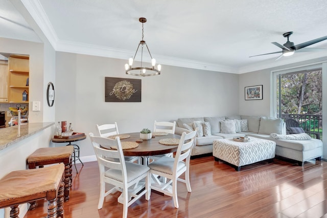 2022 Alta Meadows Ln Unit 605, Delray Beach, FL 33444 - dining space with a chandelier, wood finished floors, ceiling fan, and crown molding