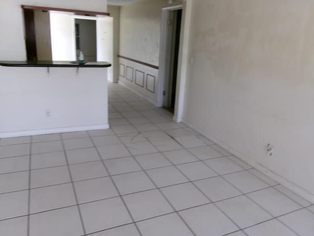 spare room featuring light tile patterned floors