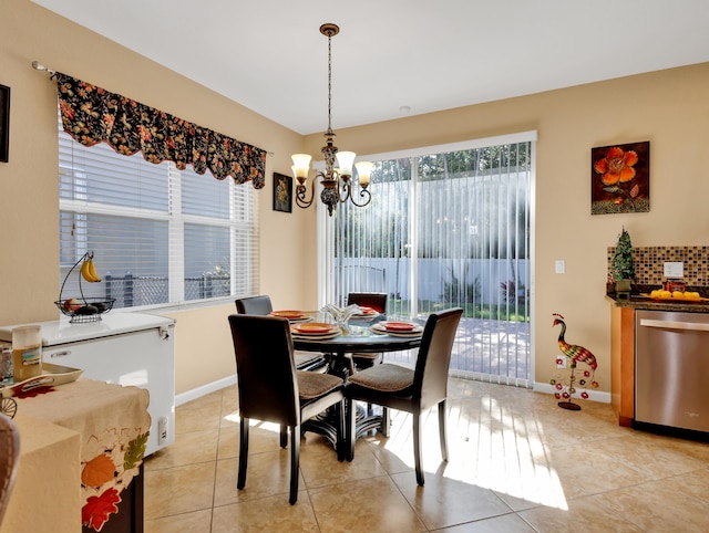 dining space with baseboards, a notable chandelier, and light tile patterned floors