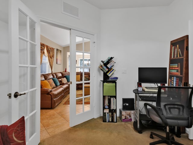 carpeted home office featuring french doors and visible vents