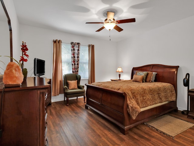 bedroom with ceiling fan and dark wood-style flooring