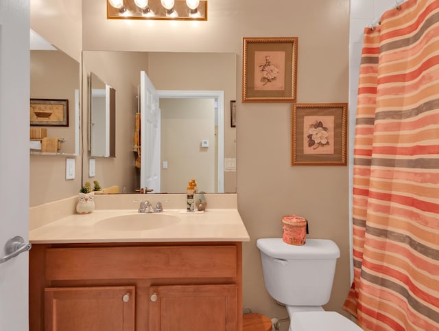 full bath with vanity, toilet, and curtained shower