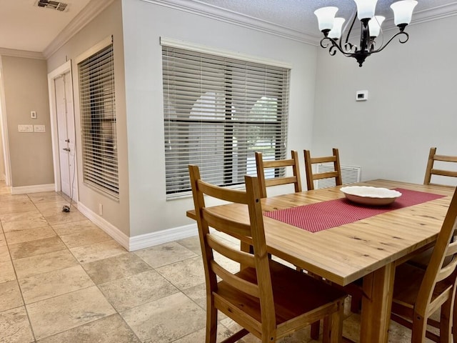dining room featuring ornamental molding, a chandelier, and baseboards