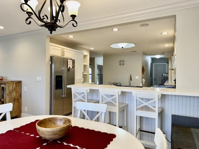 dining space featuring crown molding, recessed lighting, and a chandelier