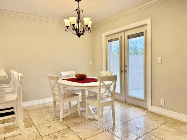 dining area featuring french doors, ornamental molding, baseboards, and a chandelier
