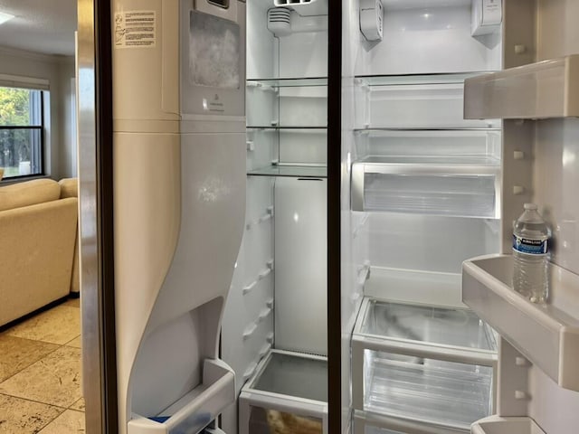 kitchen view of ornamental molding and refrigerator