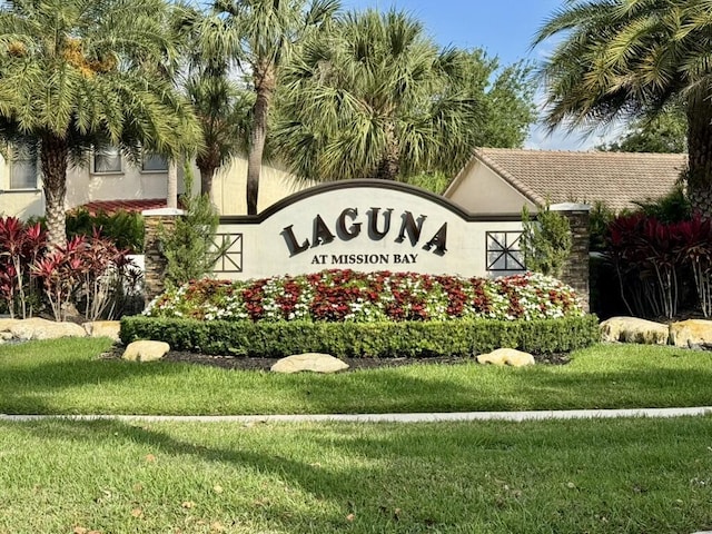 community / neighborhood sign with a lawn