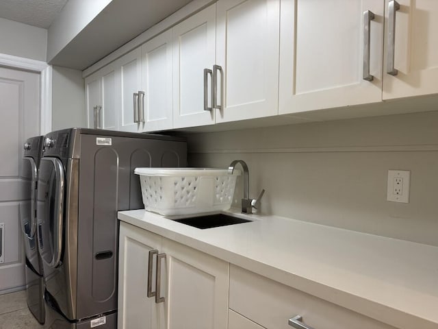 laundry room with washer and clothes dryer and cabinet space