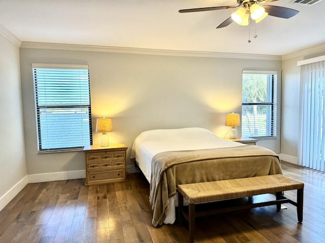 bedroom featuring hardwood / wood-style floors, crown molding, baseboards, and a ceiling fan