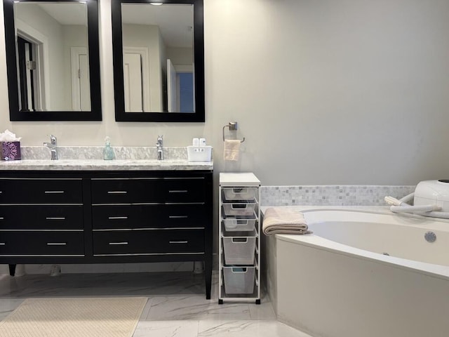 bathroom featuring double vanity, marble look tile flooring, and a garden tub