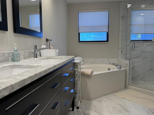 bathroom featuring marble look tiles, a marble finish shower, a garden tub, and plenty of natural light