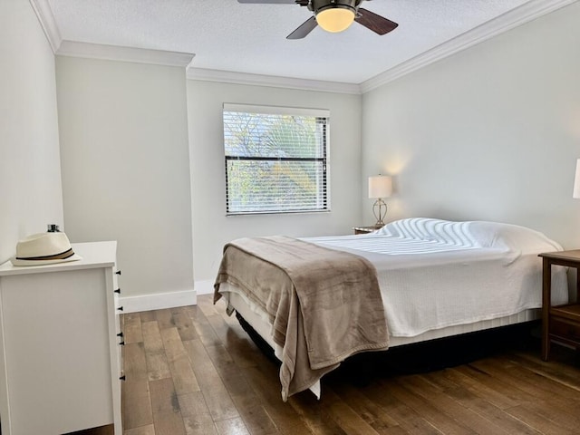 bedroom featuring wood-type flooring, crown molding, ceiling fan, and baseboards