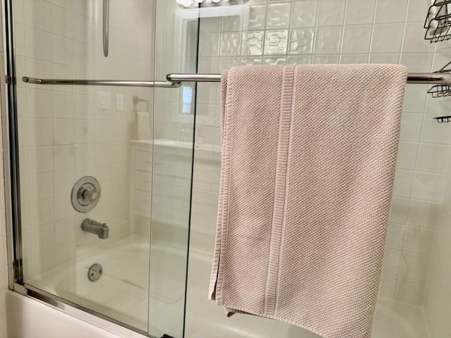 full bath featuring combined bath / shower with glass door