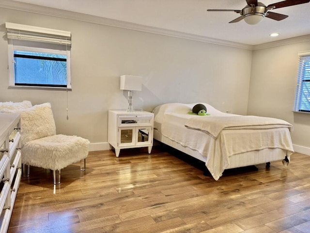 bedroom featuring ornamental molding, baseboards, hardwood / wood-style floors, recessed lighting, and a ceiling fan