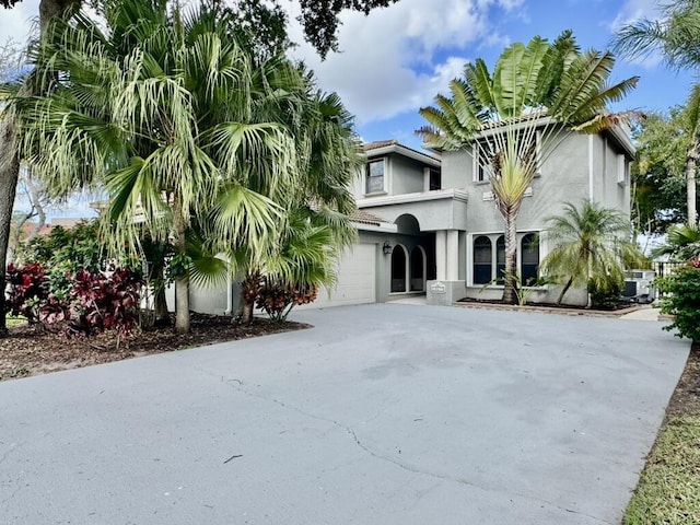 view of front of property with concrete driveway, stucco siding, and a garage