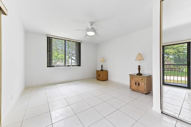 unfurnished room with ceiling fan and light tile patterned flooring