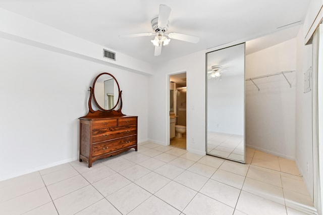 bedroom with a ceiling fan, a closet, light tile patterned floors, baseboards, and visible vents
