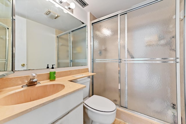 full bath featuring vanity, visible vents, a shower stall, and toilet