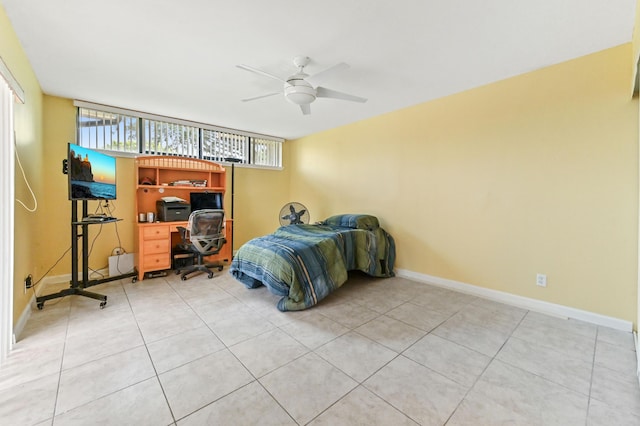 bedroom featuring light tile patterned flooring, a ceiling fan, and baseboards
