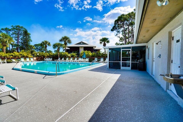 3302 SE Guinevere Ln, Port Saint Lucie, FL 34952 - community pool with a sunroom and a patio area