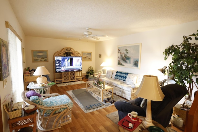 3302 SE Guinevere Ln, Port Saint Lucie, FL 34952 - living room featuring a ceiling fan, a textured ceiling, and wood finished floors