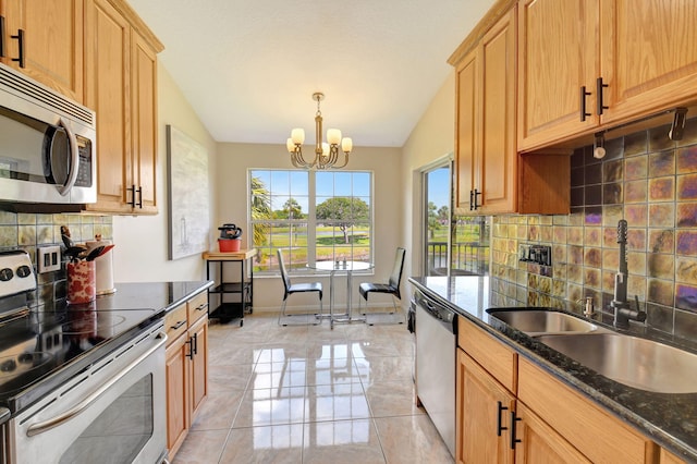 17051 Emile St Unit 5, Boca Raton, FL 33487 - kitchen with vaulted ceiling, a sink, tasteful backsplash, appliances with stainless steel finishes, and a notable chandelier