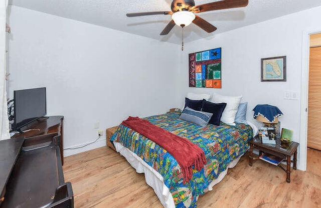 bedroom with a ceiling fan and wood finished floors
