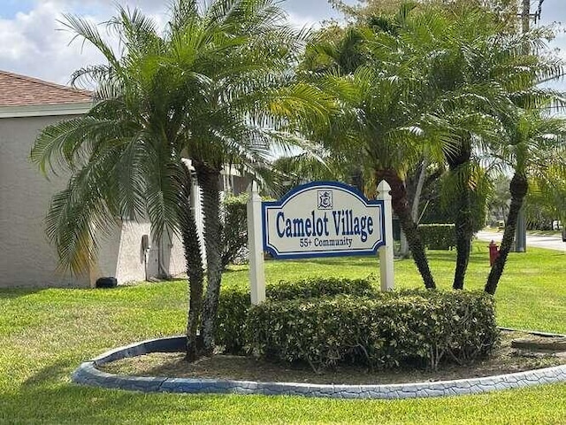 community sign featuring a lawn
