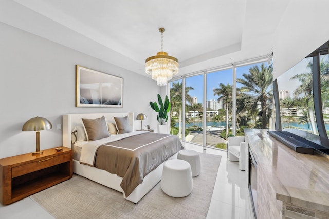 bedroom featuring multiple windows, a notable chandelier, and light tile patterned floors
