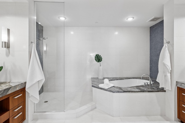 full bathroom with tile patterned floors, visible vents, vanity, a bath, and walk in shower