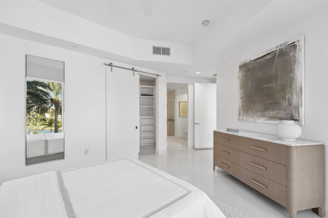 unfurnished bedroom with a barn door, recessed lighting, visible vents, and light tile patterned floors